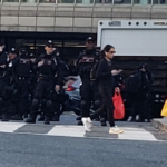 Row of police at an intersection.