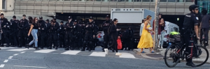 Row of police at an intersection.